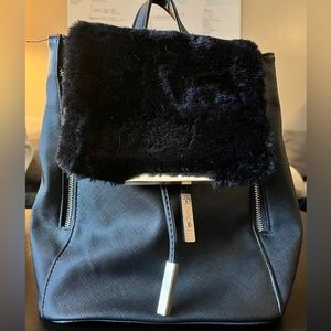 Black medium size backpack with gold hardware and black furry top